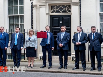 George Osborne MP, First Secretary of State and Chancellor of the Exchequer holds up the Red Box otherwise known as the Budget Box to announce his annual budget plans.