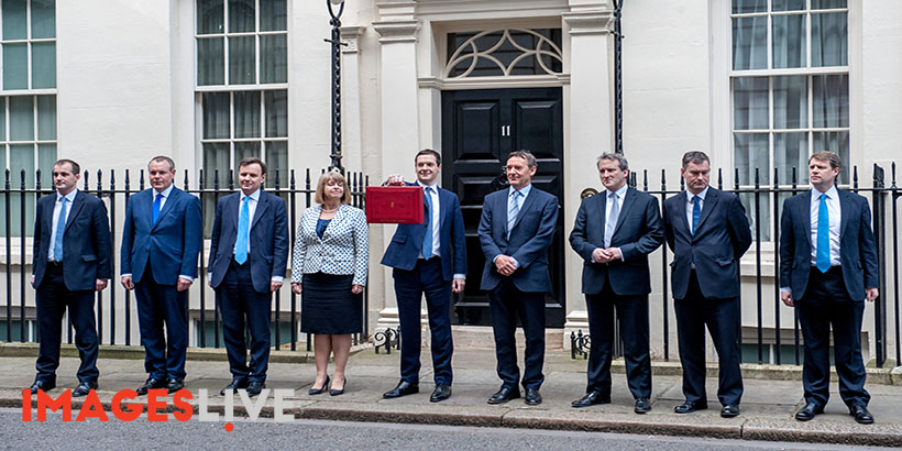 George Osborne MP, First Secretary of State and Chancellor of the Exchequer holds up the Red Box otherwise known as the Budget Box to announce his annual budget plans.