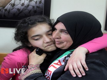 The mother (R) of Palestinian Dima al-Wawi, 12, who is believed to be the youngest female detained by Israel, greets her in the West Bank city of Tulkarem, upon her release from Israeli prison on April 24, 2016. (Mohammed Turabi).