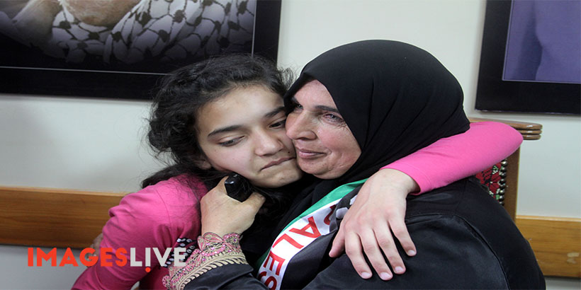 The mother (R) of Palestinian Dima al-Wawi, 12, who is believed to be the youngest female detained by Israel, greets her in the West Bank city of Tulkarem, upon her release from Israeli prison on April 24, 2016. (Mohammed Turabi).