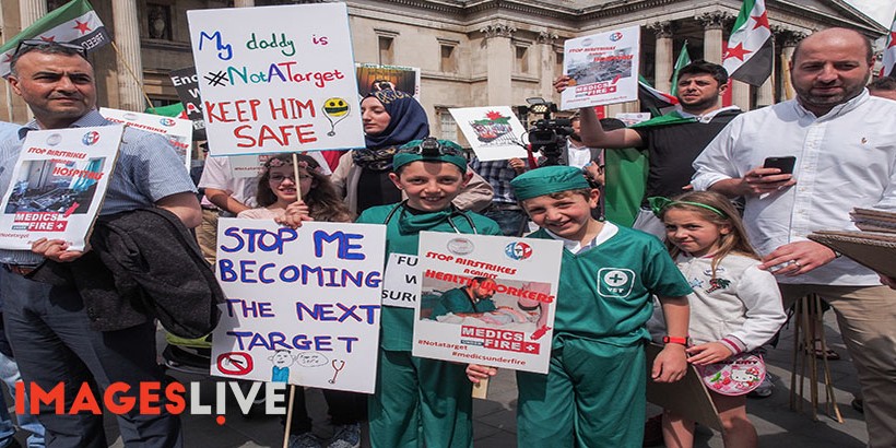 Healthcare workers, human rights advocates and leaders of organisations providing healthcare in war zones held a 'Medics Undre Fire' rally in Trafagar Square, protesting over the many recent devastating military attacks on hospitals and clinics taking place in war zones, especially Syria and Yemen. The campaigners then marched to Downing Street where they tried unsuccesfully to hand in a letter. The protesters were joined by comedian, writer & producer Jolyon Rubenstein.