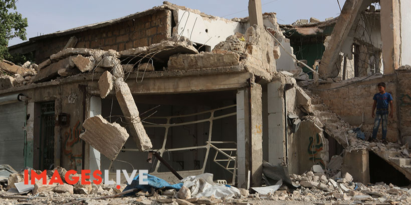 A Syrian child looks at the destruction following an airstrike in the town of Atarib, west of Aleppo. Photographer: Juma Muhammad/Images Live